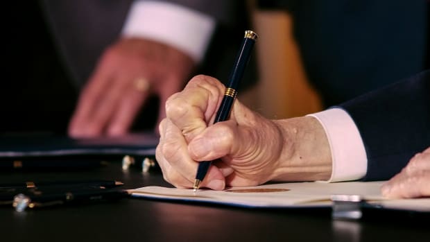 Ohio Gov. Mike DeWine signs an executive order permitting college student-athletes to profit off their name, image and likeness during a ceremonial signing on Monday, June 28, 2021 at the Ohio Statehouse in Columbus, Ohio. Mike Dewine Signs Executive Order Permitting Name Image Likeness